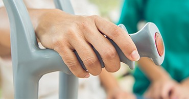 patient using crutches due to a neurodegenerative disease